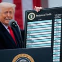 President Donald Trump holds up a chart of "reciprocal tariffs" while speaking during a trade announcement event in the Rose Garden at the White House.