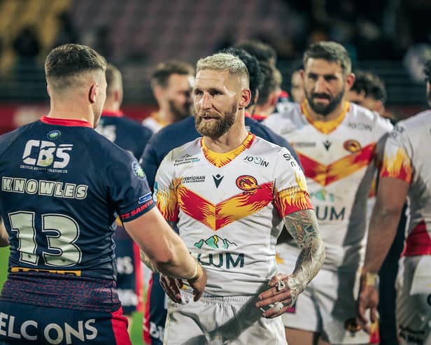 Catalans Dragons star Sam Tomkins (right) shaking hands with St Helens forward Morgan Knowles (left)
