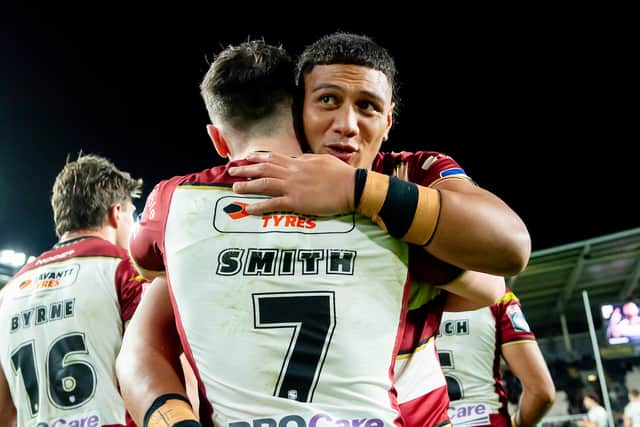 Patrick Mago hugs Wigan Warriors teammate Harry Smith after a Wigan Warriors victory