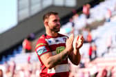 Kaide Ellis applauds the Wigan Warriors fans