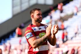 Kaide Ellis applauds the Wigan Warriors fans