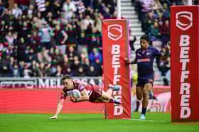 Jai Field scoring a try for Wigan Warriors against St Helens on Good Friday