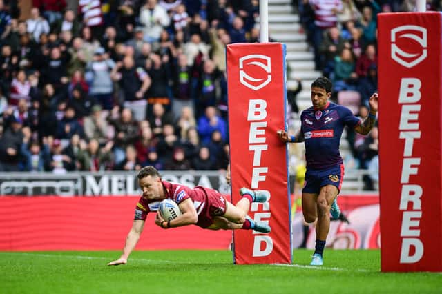 Jai Field scoring a try for Wigan Warriors against St Helens on Good Friday