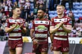 From left to right: Jai Field, Bevan French and Zach Eckersley applaud the fans after Wigan Warriors' win over St Helens on Good Friday