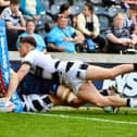 Wigan Warriors winger Abbas Miski scores a try against Hull FC in Round Nine of Super League
