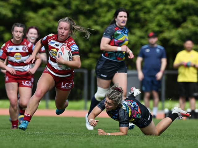 Ellise Derbyshire makes a break for Wigan Warriors against Cardiff Demons