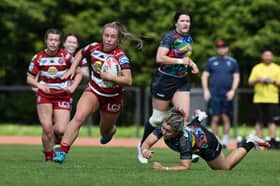 Ellise Derbyshire makes a break for Wigan Warriors against Cardiff Demons
