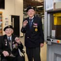 Veterans Richard Pelzer (left), 101, and Ron Horsey, 98, who both served with the Royal Engineers, holding the new VE Day 50p coin at the Royal Mint manufacturing site in South Wales (Photo: The Royal Mint)