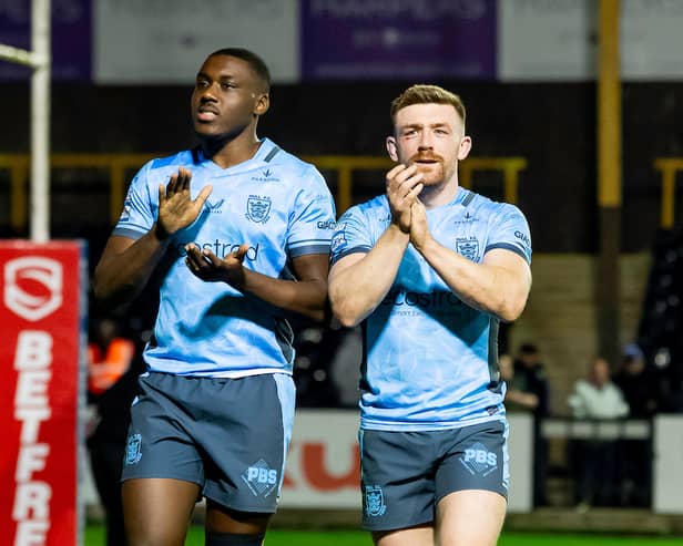 Sam Eseh (left) and Ed Chamberlain (right) applaud the Hull FC fans after a game