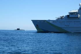 A “secret weapon” is being developed and could be used by Royal Navy technicians to search for Russian submarines. Pictured: HMS Tyne with Russian Kilo-class submarine Krasnodar in the background.