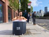 A commuter takes an ice bath at a London bus stop