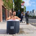 A commuter takes an ice bath at a London bus stop