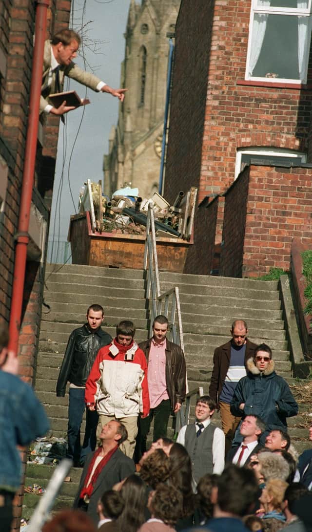 Oasis are seemingly preached at in a side street in Wigan.