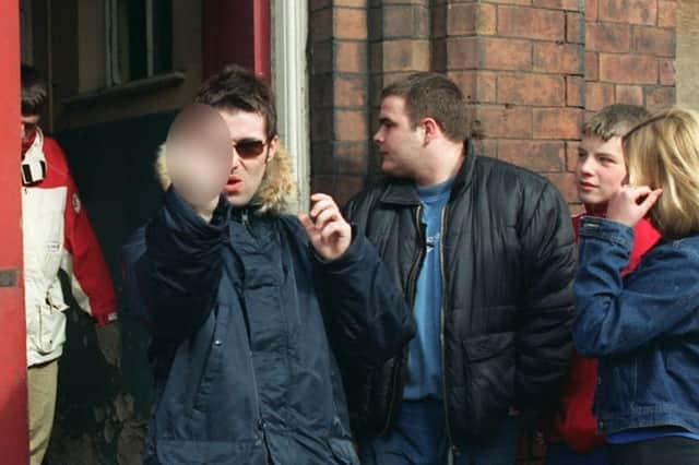 Liam Gallagher sticks two fingers up at the camera in Wigan.