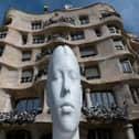 A sculpture entitled 'Flora', by Spanish artist Jaume Plensa is displayed during 'Jaume Plensa, poetry of silence' exhibition in front of Spanish architect Antonio Gaudi's "Casa Mila" building, commonly known as "La Pedrera" in Barcelona. 
