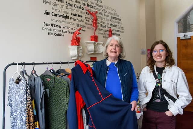 Maureen Schofield (left) shows a visitor some of the theatre's costumes