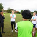 Theo Walcott and Josh Paul offer guidance to young players at Teviot Rangers JFC
