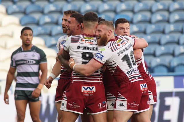 Wigan Warriors prop Luke Thompson celebrating a try against Huddersfield Giants with his team-mates