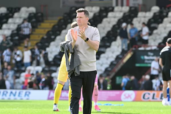 Gary Caldwell applauds the Wigan Athletic fans at Grimsby Town