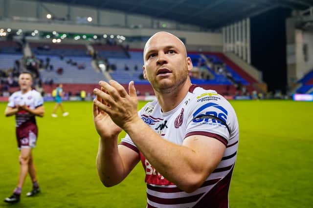 Liam Marshall applauds the Wigan Warriors fans