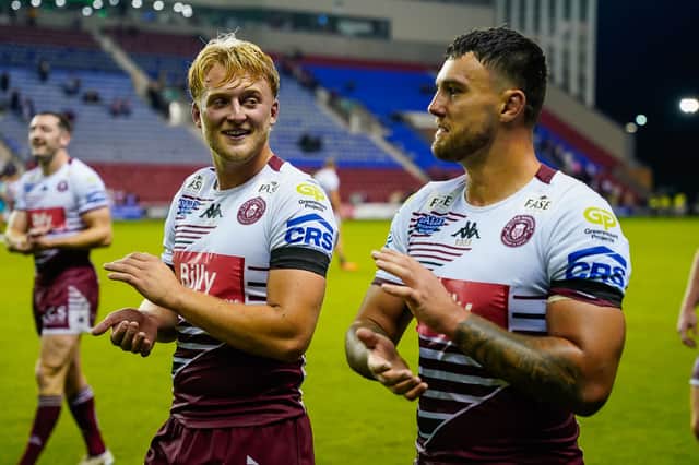 Taylor Kerr (left) and Ollie Partington (right) applaud the Wigan Warriors fans