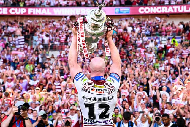 Wigan Warriors captain Liam Farrell lifting the Challenge Cup at Wembley