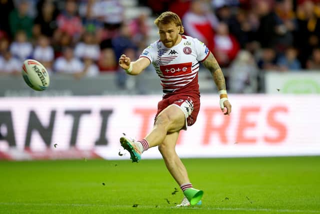 Adam Keighran kicking a goal for Wigan Warriors