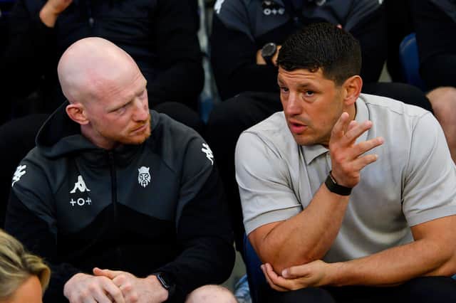 Wigan Warriors captain Liam Farrell (left) in conversation with head coach Matt Peet (right)