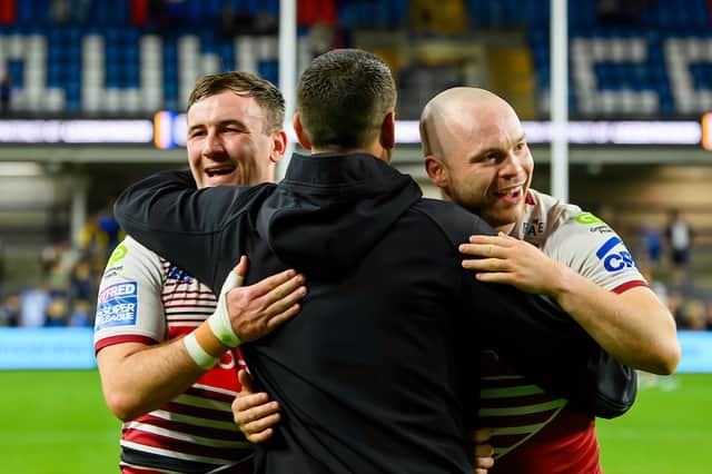 Matt Peet (centre) celebrates Wigan's win over Leeds with Harry Smith (left) and Liam Marshall (right)