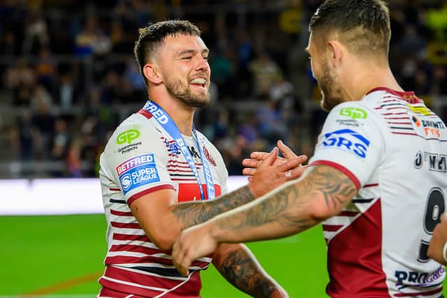 Ollie Partington (left) and Brad O'Neill (right) embrace after Wigan's win over Leeds