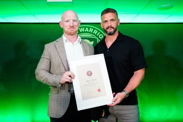 Liam Farrell (left) is presented with his Wigan Warriors Hall of Fame certificate by Sean O'Loughlin (right)