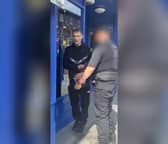 Wayne Kelly in handcuffs just after paedophile hunters made a citizens' arrest at Wigan North Western