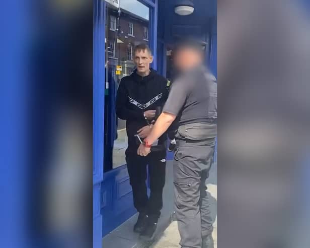 Wayne Kelly in handcuffs just after paedophile hunters made a citizens' arrest at Wigan North Western
