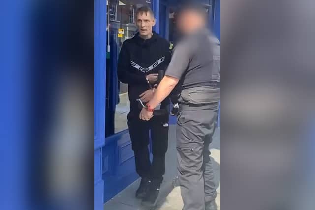 Wayne Kelly in handcuffs just after paedophile hunters made a citizens' arrest at Wigan North Western