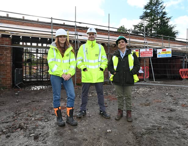 Construction project manager Ellie Colling, operations director Peter Hughes and Dr Sylvia Travers, head of  horticulture and landscape, outside the bothy at Haigh Woodland Park