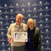 A dedicated Wigan volunteer collects an award from the National Association of Boys and Girls Clubs