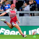 Izzy Rowe kicking a goal for Wigan Warriors