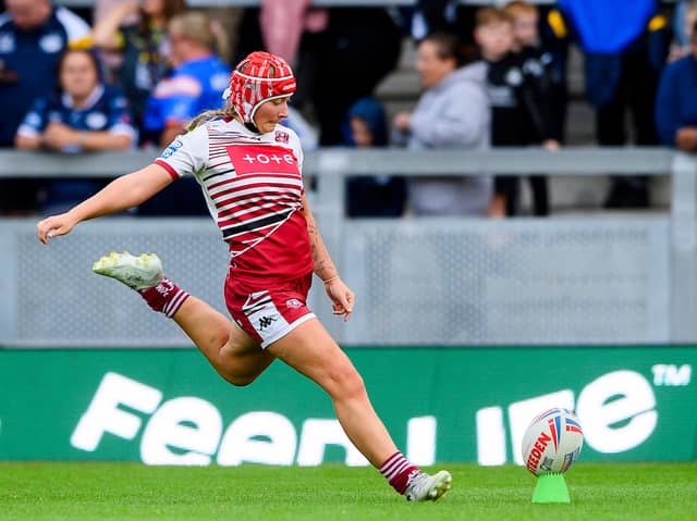Izzy Rowe kicking a goal for Wigan Warriors