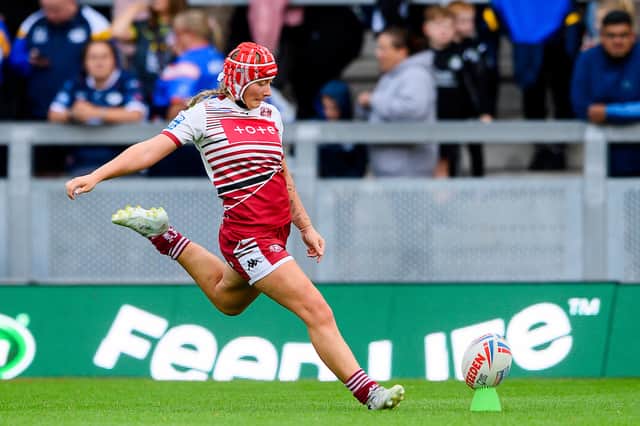 Izzy Rowe kicking a goal for Wigan Warriors