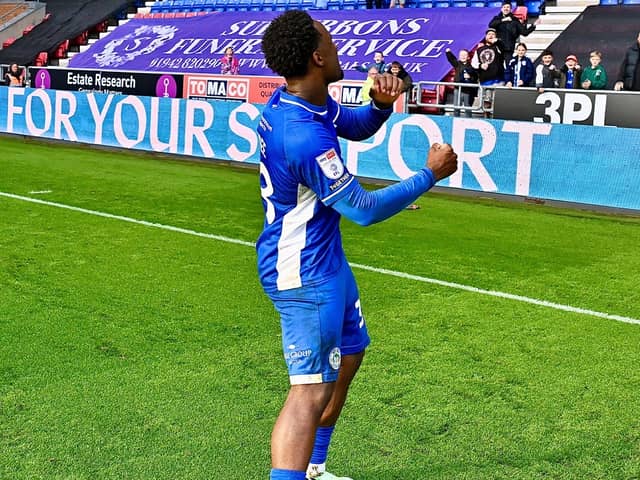 Christian Saydee celebrates a big three points with the Latics fans