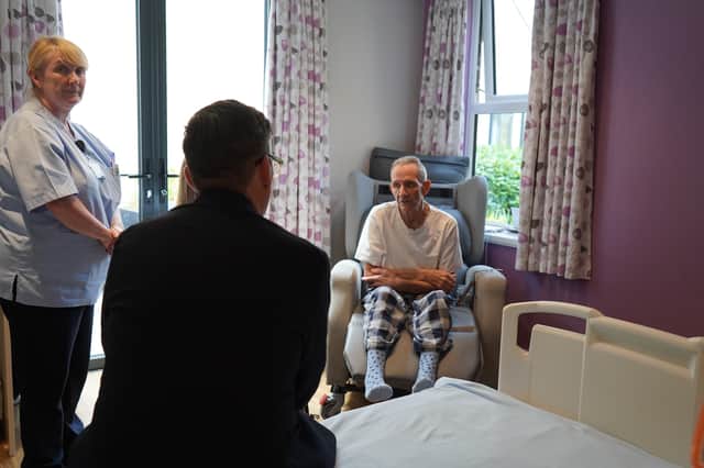 Andy Burnham talking to a Wigan and Leigh Hospice patient