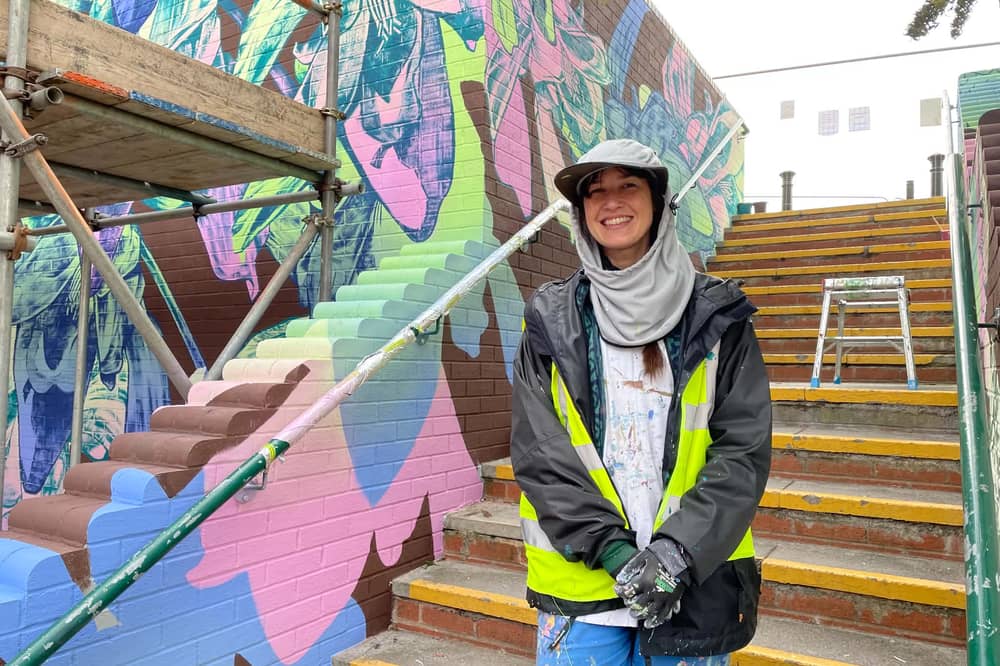 George Rose at her mural next to the steps at Greensway shopping centre
