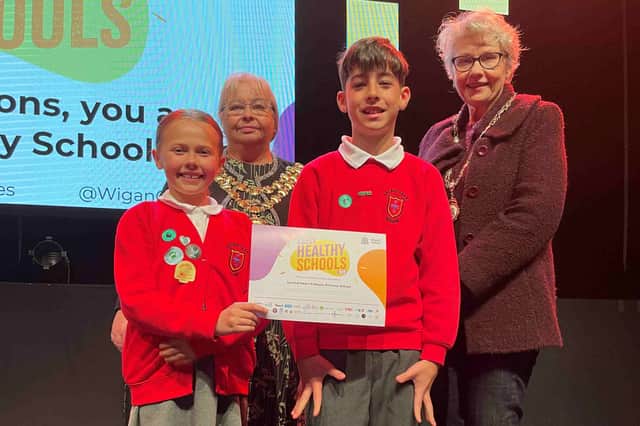 Pupils from Sacred Heart Wigan receive their certificate from the Mayor, Cllr Anne Collins