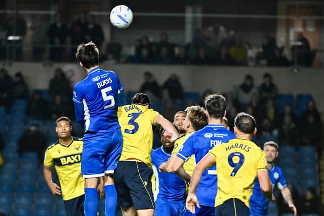 Finley Burns wins a header at Oxford but it proved to be in vain