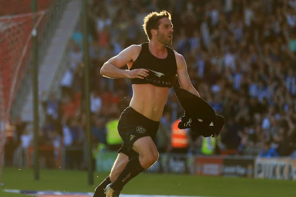 Will Grigg celebrates scoring the League One-winning goal at Doncaster in 2018