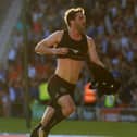 Will Grigg celebrates scoring the League One-winning goal at Doncaster in 2018