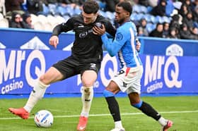 Connor Barrett fights for the ball at Huddersfield