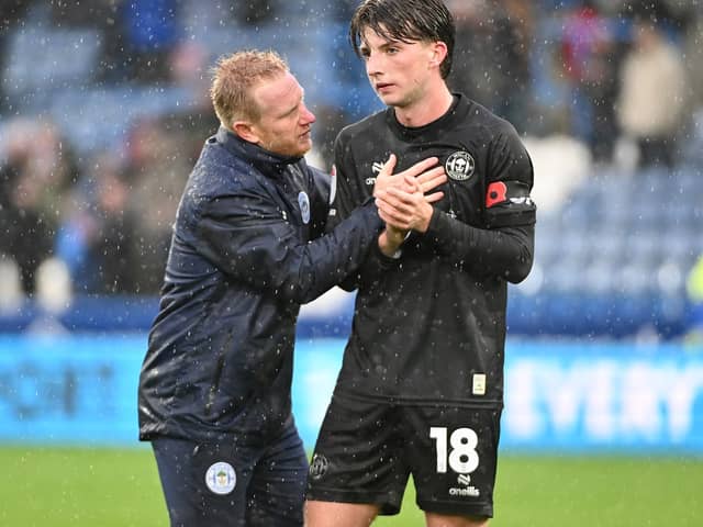 David Perkins consoles Charlie Gray after Latics' defeat at Huddersfield