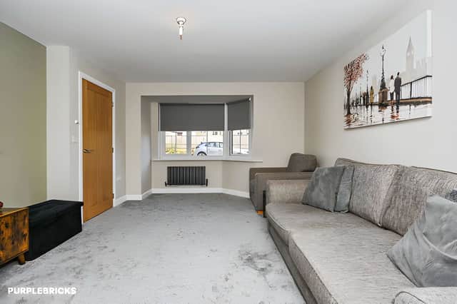The generous living room flows through to a separate dining room, creating connected spaces for relaxing, family meals and entertaining.