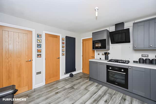 A new fitted kitchen with wall and base units and practical worktop space forms the heart of the home's everyday cooking arrangements.